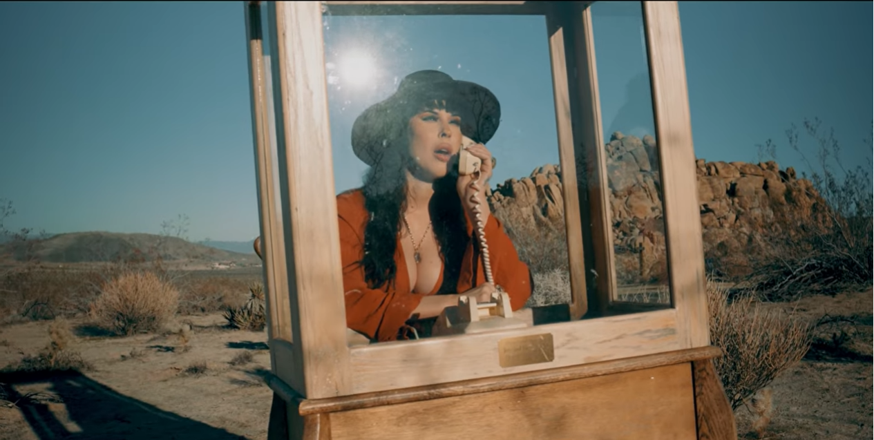 Blythe Vermilion in a vintage telephone booth in the desert